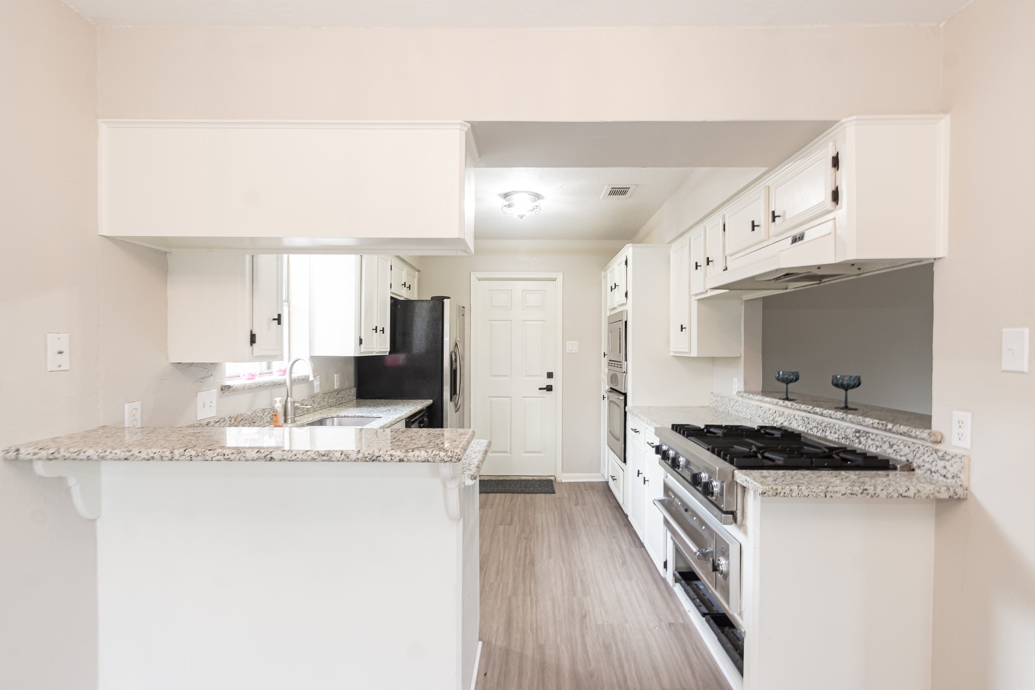 29019 Stapleford Street Spring, TX 77386 - Photo 9 of 27 a kitchen with stainless steel appliances granite countertop a stove a sink and a refrigerator