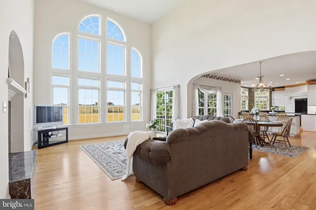 a kitchen with stainless steel appliances granite countertop a sink a stove cabinets counter space and a window