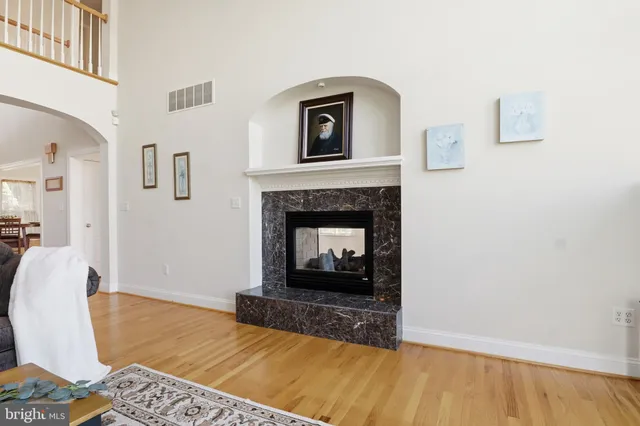 a view of an empty room with a fireplace and a window