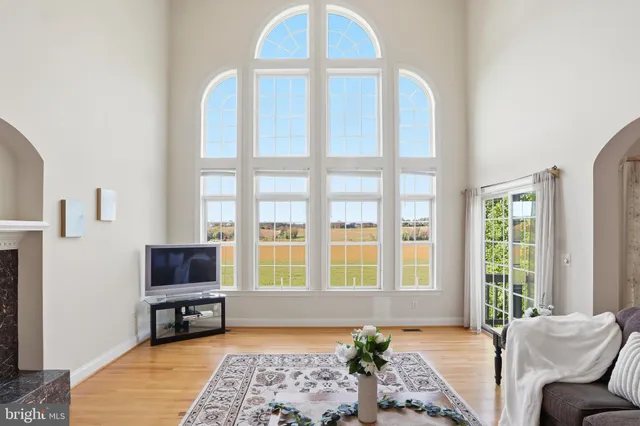 a view of a hallway with wooden floor and stairs