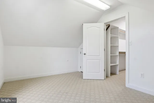 an aerial view of a house with a garden and lake view