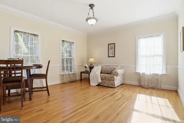 a living room with furniture a fireplace and a large window