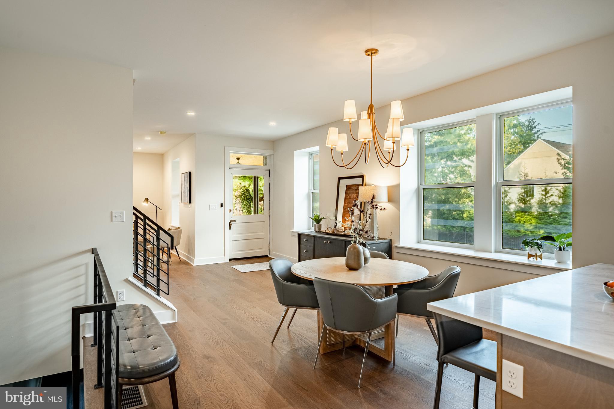 101 Grandview Road Ardmore, PA 19003 - Photo 18 of 55 a dining room with wooden floor a chandelier a wooden table and chairs