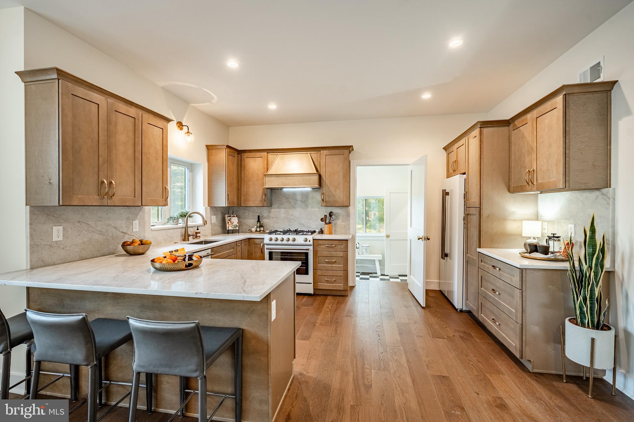 101 Grandview Road Ardmore, PA 19003 - Photo 19 of 55 a kitchen with a table chairs refrigerator and cabinets