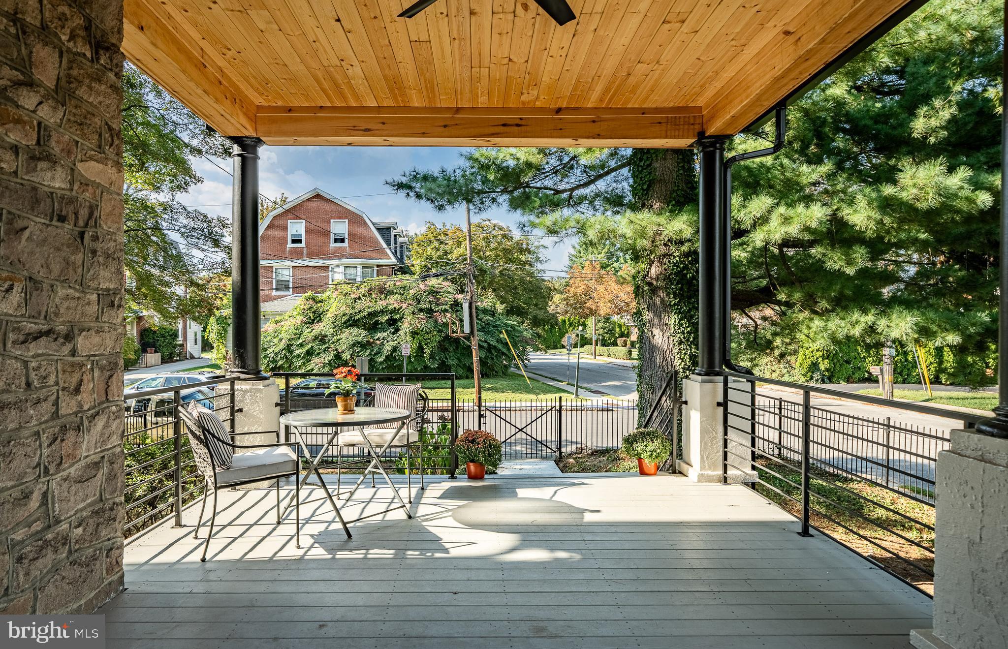 101 Grandview Road Ardmore, PA 19003 - Photo 4 of 55 a view of a patio with a table and chairs under an umbrella with a small yard