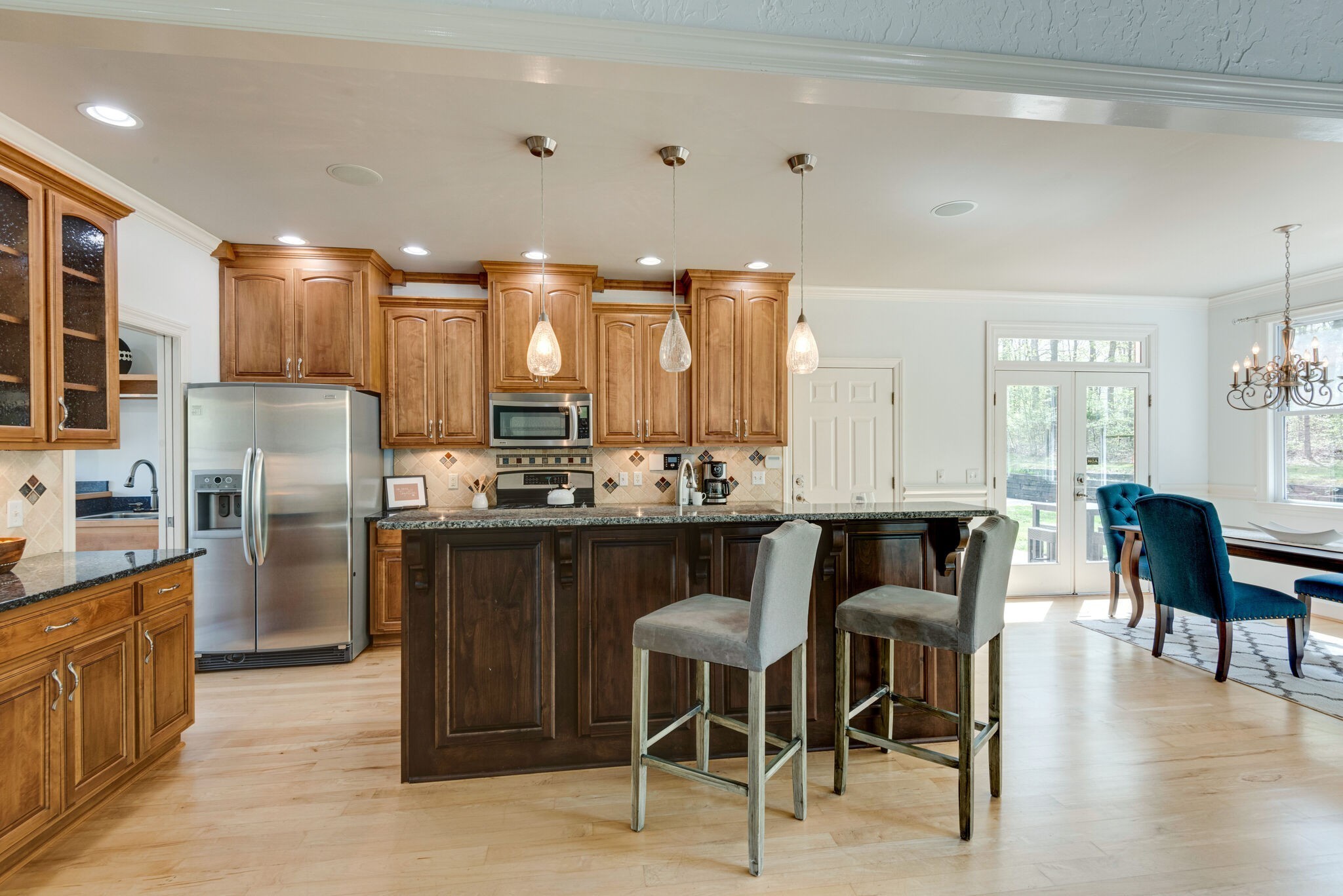 1288 2 Mile Road Burns, TN 37029 - Photo 19 of 70 a kitchen with stainless steel appliances kitchen island granite countertop a table chairs sink and cabinets
