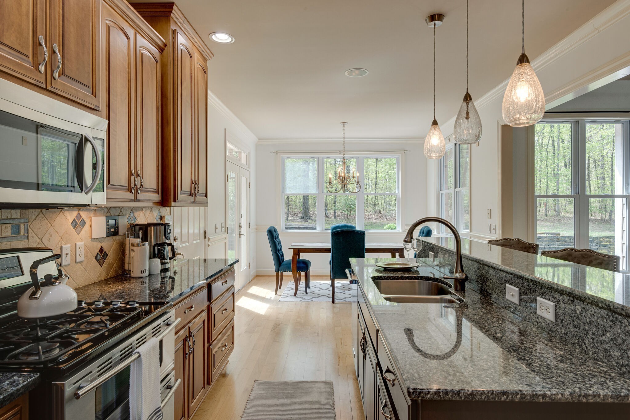 1288 2 Mile Road Burns, TN 37029 - Photo 20 of 70 a kitchen with stainless steel appliances a stove a sink a dining table and chairs