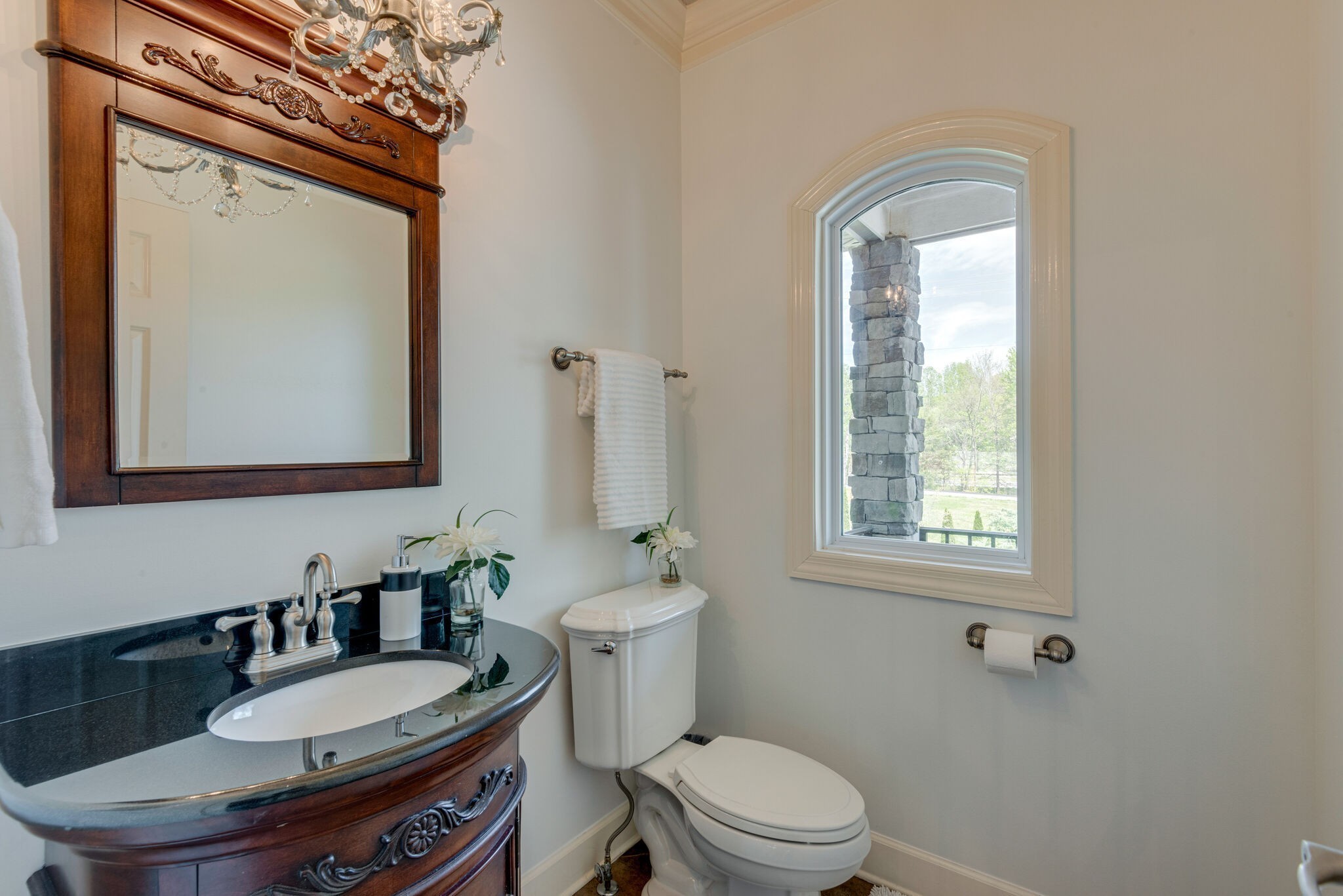 1288 2 Mile Road Burns, TN 37029 - Photo 22 of 70 a bathroom with a granite countertop toilet a sink a mirror and a window