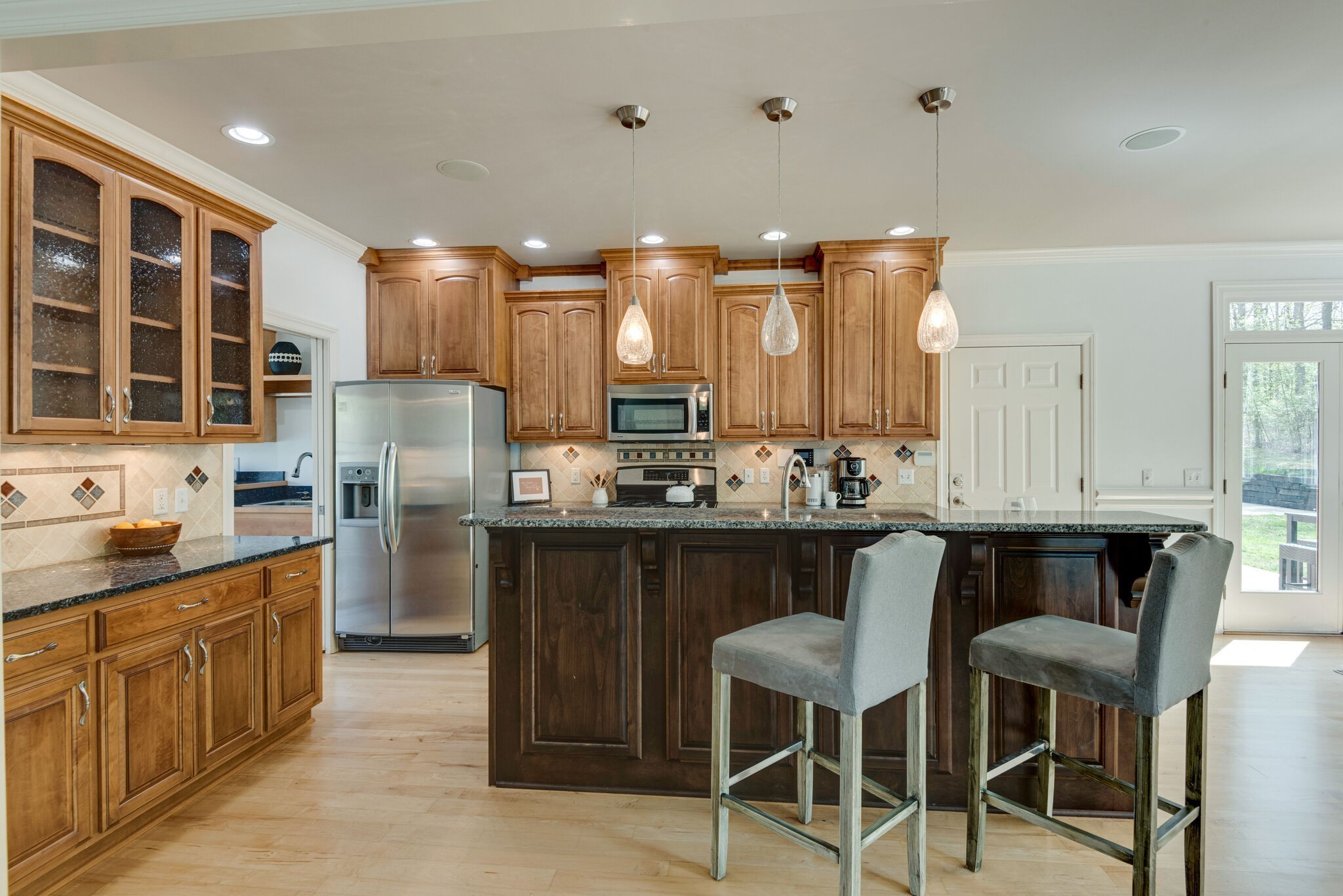 1288 2 Mile Road Burns, TN 37029 - Photo 26 of 70 a kitchen with a refrigerator a sink dishwasher with a dining table and chairs