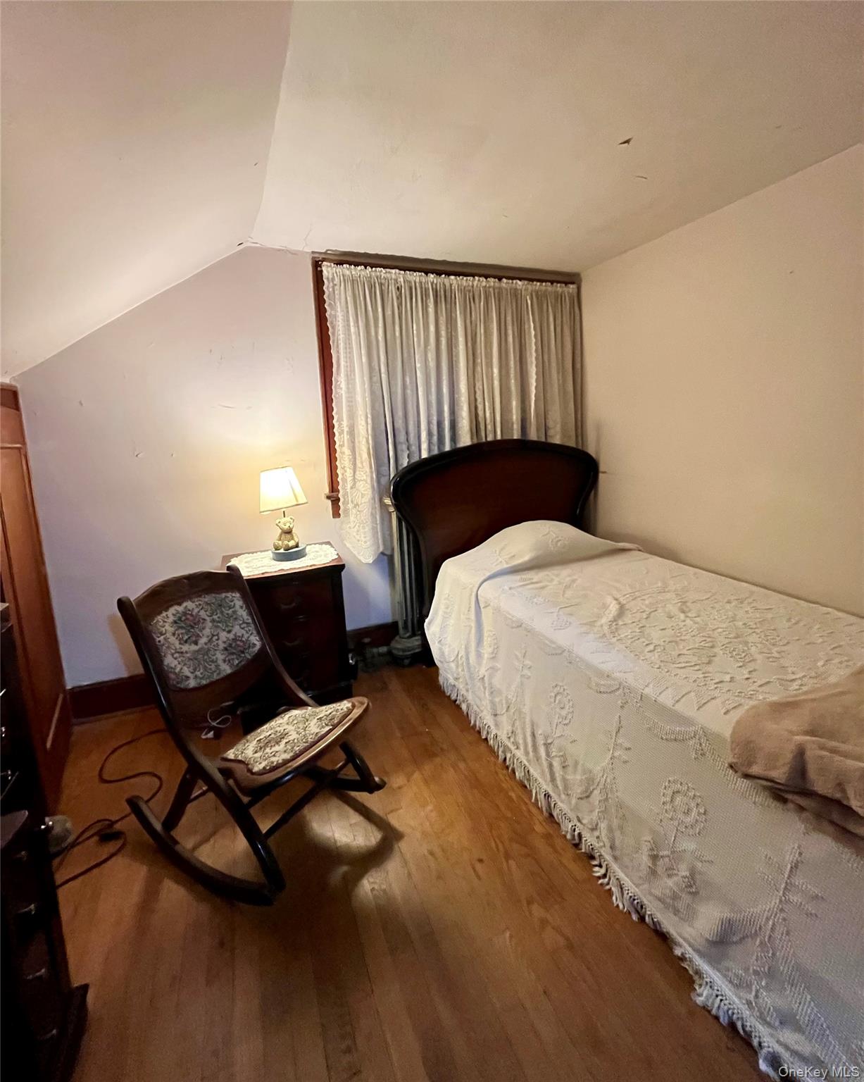 35 Spring Street Goshen, NY 10924 - Photo 10 of 26 a bedroom with a bed window and chair