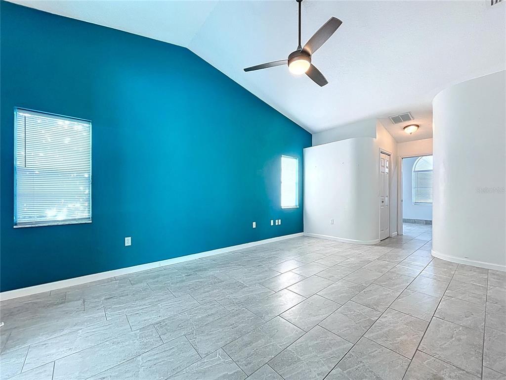 18812 Bascomb Lane Hudson, FL 34667 - Photo 37 of 57 an empty room with ceiling fan and window