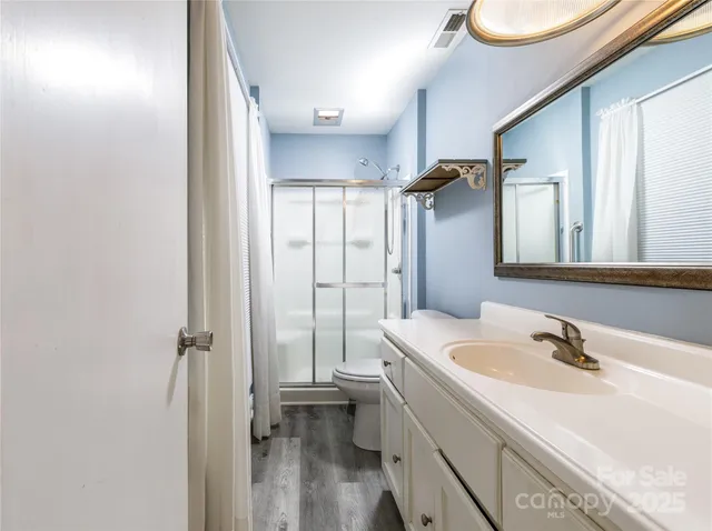 a bathroom with a sink a mirror and vanity