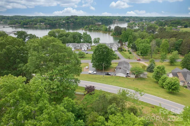 an aerial view of residential houses with outdoor space and river