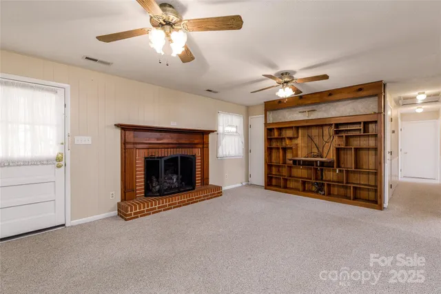 a living room with furniture a fireplace and a book shelf