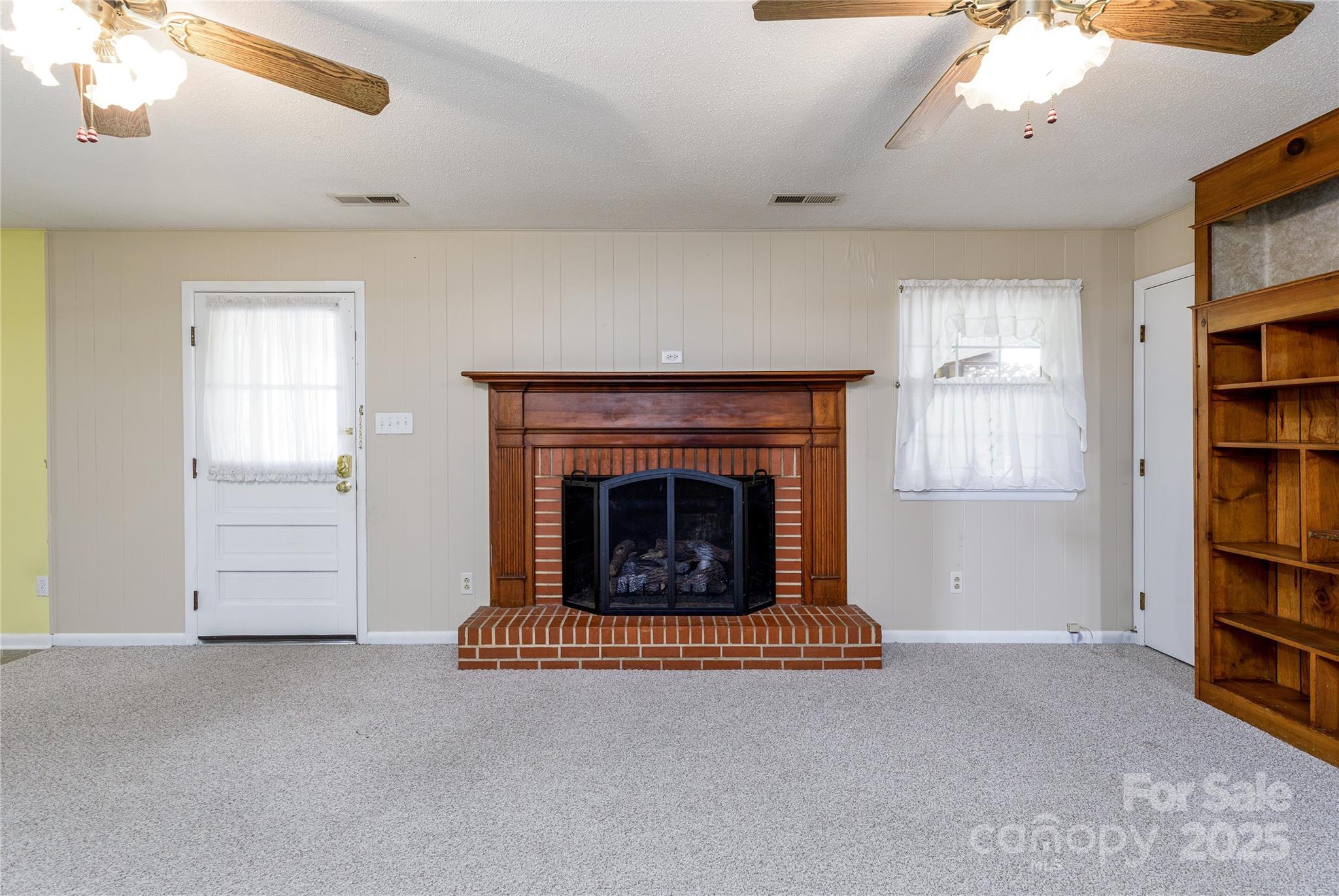 466 Shiloh Church Road Hickory, NC 28601 - Photo 22 of 45 a living room with furniture a fireplace and a book shelf