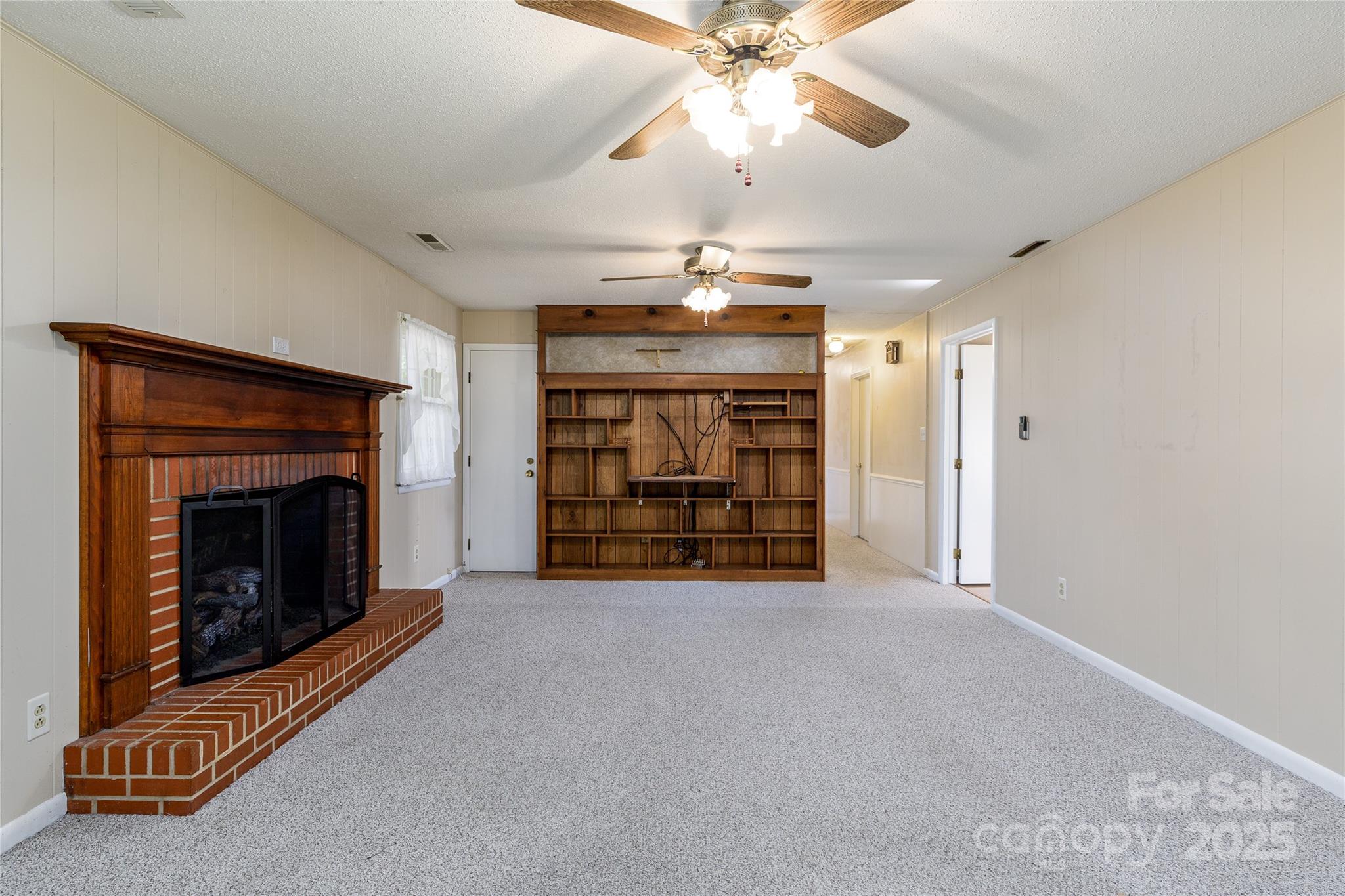 466 Shiloh Church Road Hickory, NC 28601 - Photo 23 of 45 an empty room with fireplace chandelier fan and windows