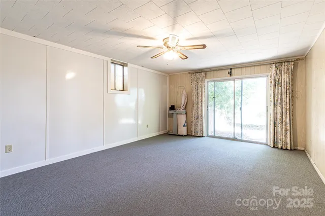a view of an empty room with a fireplace