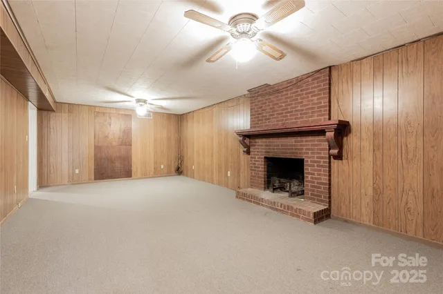 an empty room with fan and windows