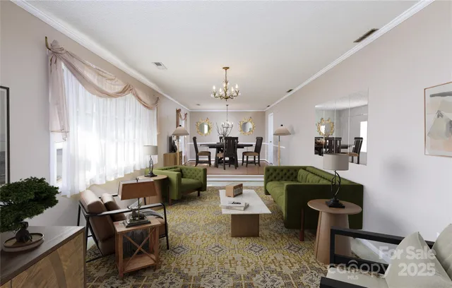 a living room with furniture and a chandelier