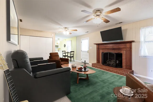 a living room with furniture and a fireplace