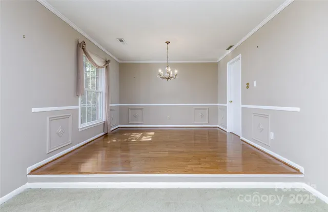 a view of water heater room with wooden floor