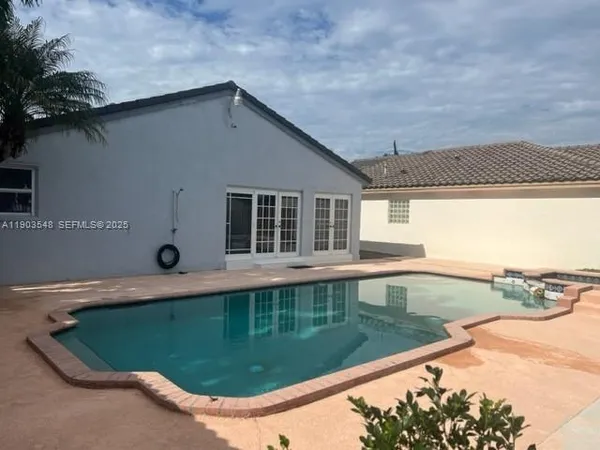 a view of a swimming pool with a yard