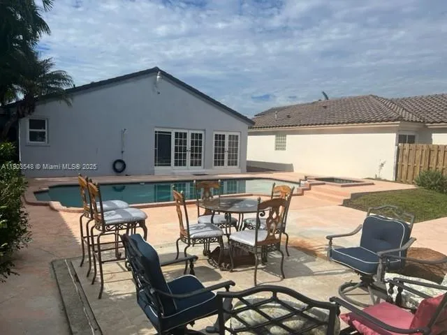 a patio with table and chairs