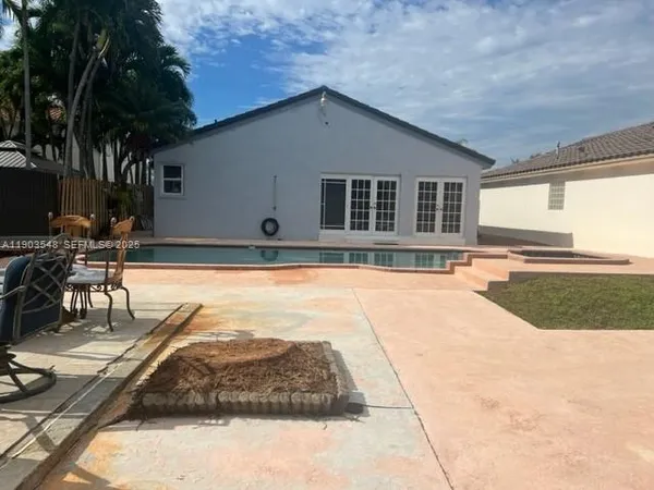 a swimming pool with outdoor seating and yard