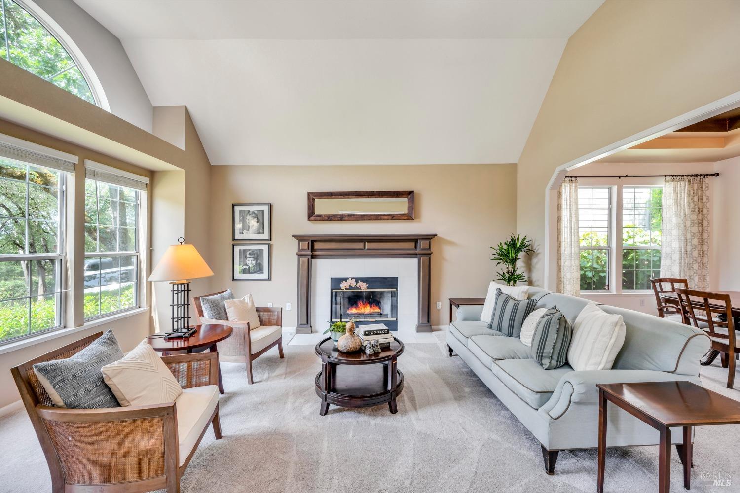 1508 Ronne Drive Santa Rosa, CA 95404 - Photo 11 of 55 a living room with furniture a fireplace and a large window