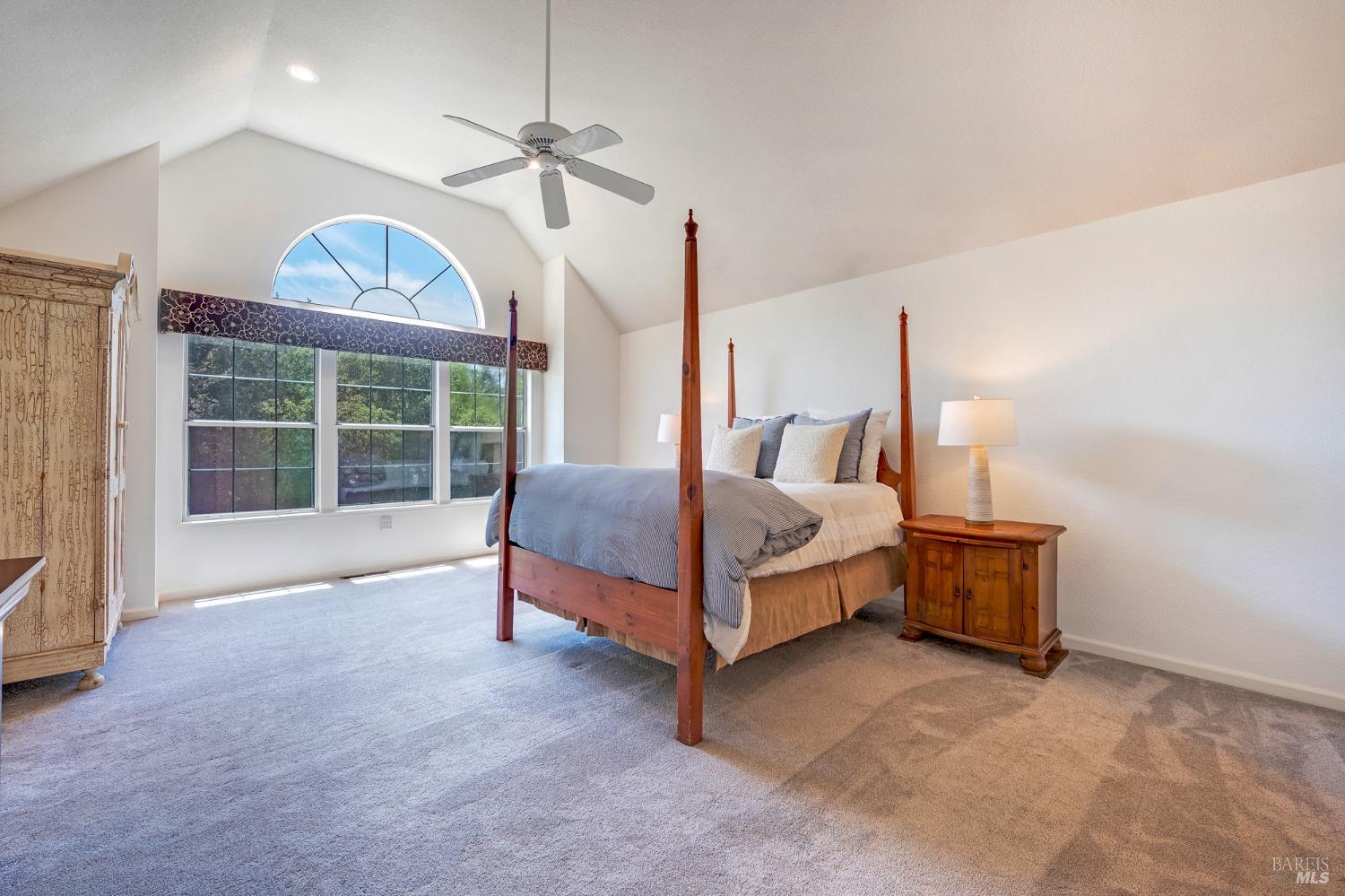 1508 Ronne Drive Santa Rosa, CA 95404 - Photo 24 of 55 a spacious bedroom with a bed a chandelier and a window