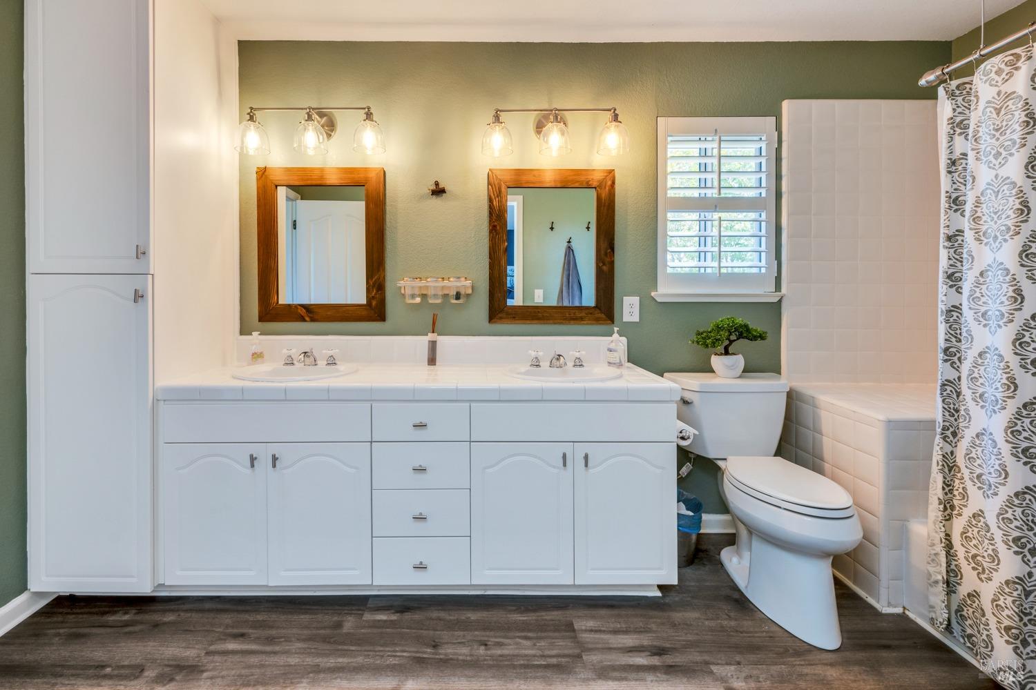 1508 Ronne Drive Santa Rosa, CA 95404 - Photo 35 of 55 a bathroom with a double vanity sink a toilet and a mirror