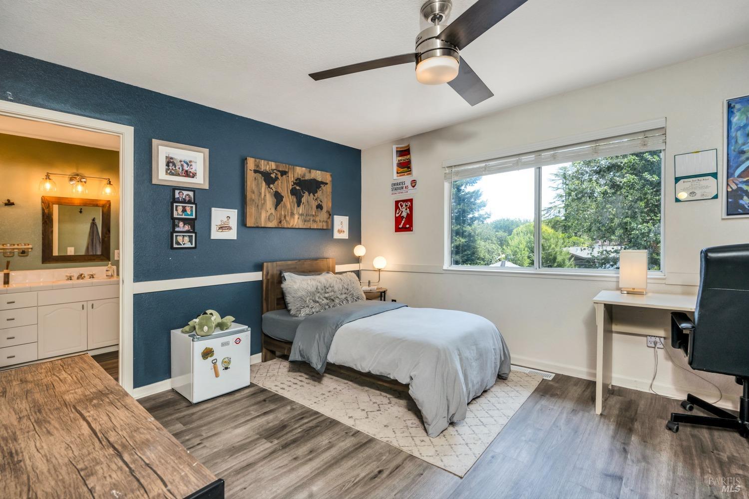 1508 Ronne Drive Santa Rosa, CA 95404 - Photo 37 of 55 a bedroom with a bed and wooden floor