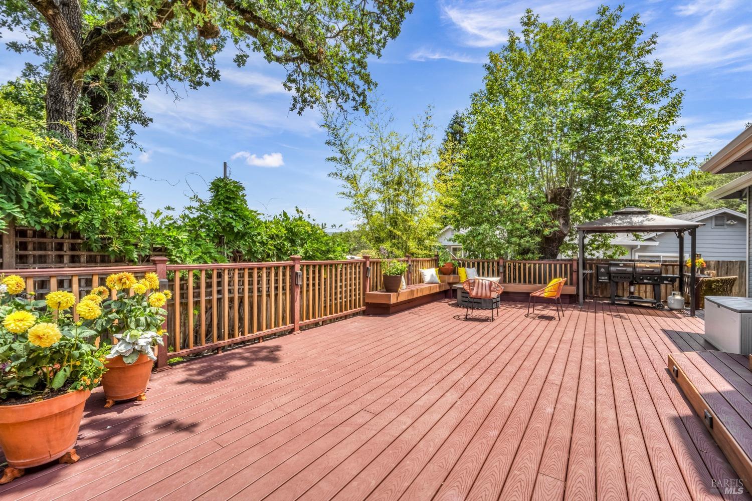 1508 Ronne Drive Santa Rosa, CA 95404 - Photo 4 of 55 a view of a patio with dining table and chairs with wooden floor and fence