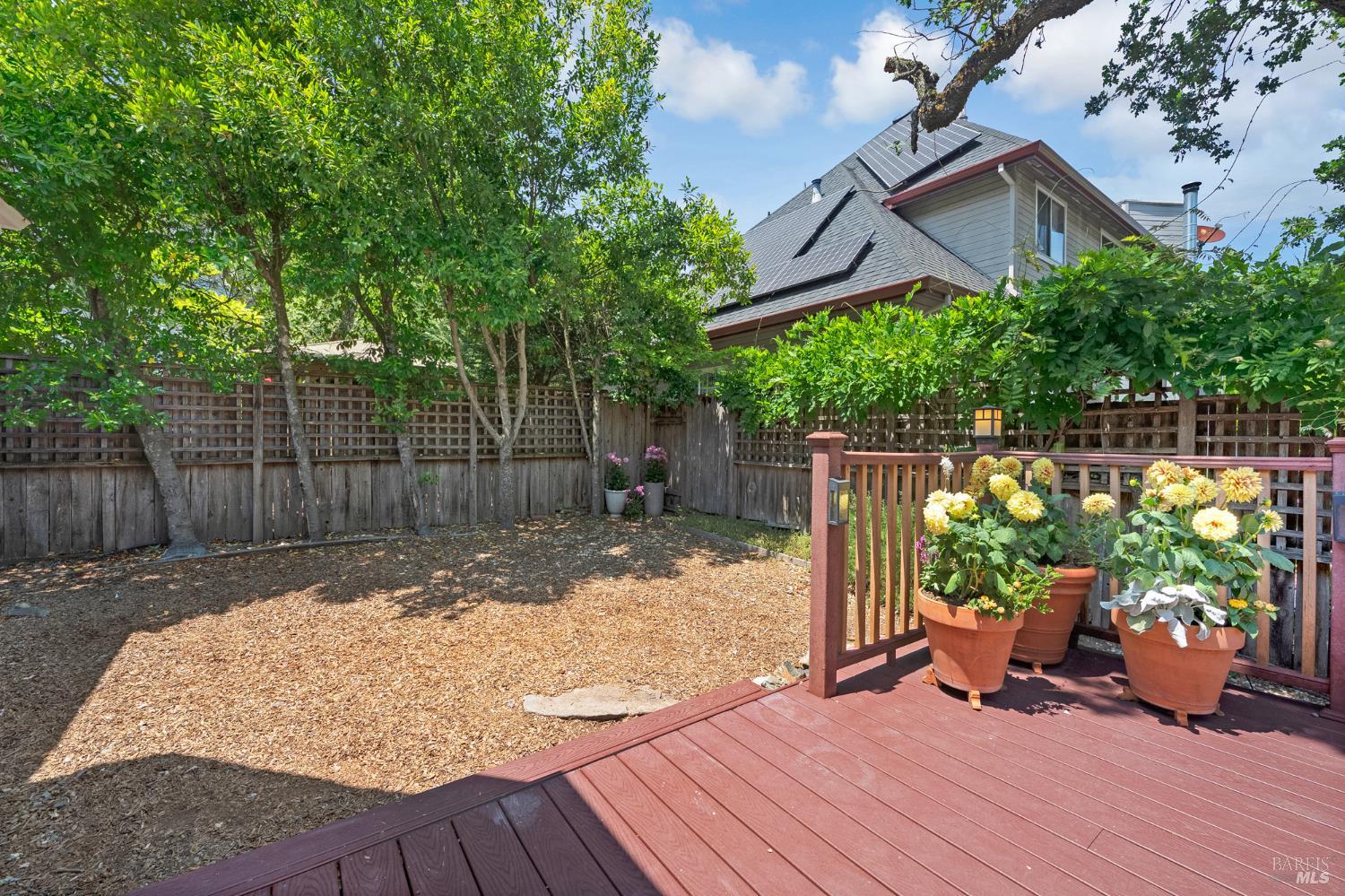 1508 Ronne Drive Santa Rosa, CA 95404 - Photo 53 of 55 a backyard of a house with table and chairs with wooden floor and fence