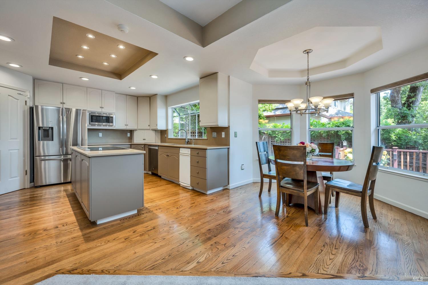 1508 Ronne Drive Santa Rosa, CA 95404 - Photo 9 of 55 a kitchen with stainless steel appliances granite countertop wooden floor a dining table and chairs