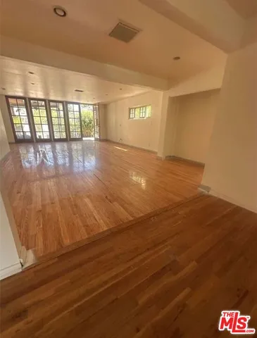 a view of an empty room and a window
