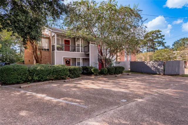 a front view of house with yard and trees