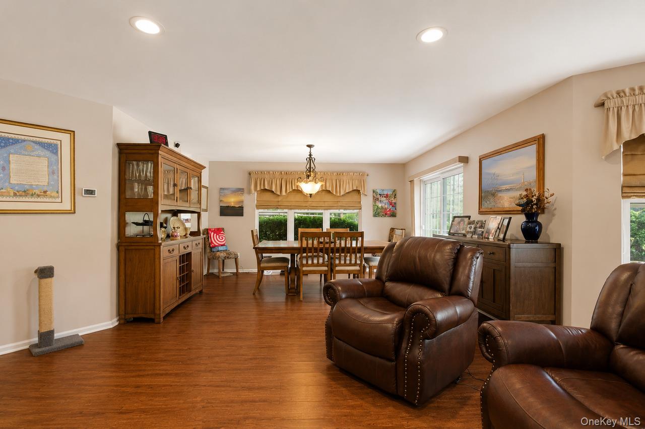 64 Roma Orchard Road Peekskill, NY 10566 - Photo 11 of 40 Open-concept living area featuring wood-finish flooring, recessed lighting, and ample natural light from multiple windows