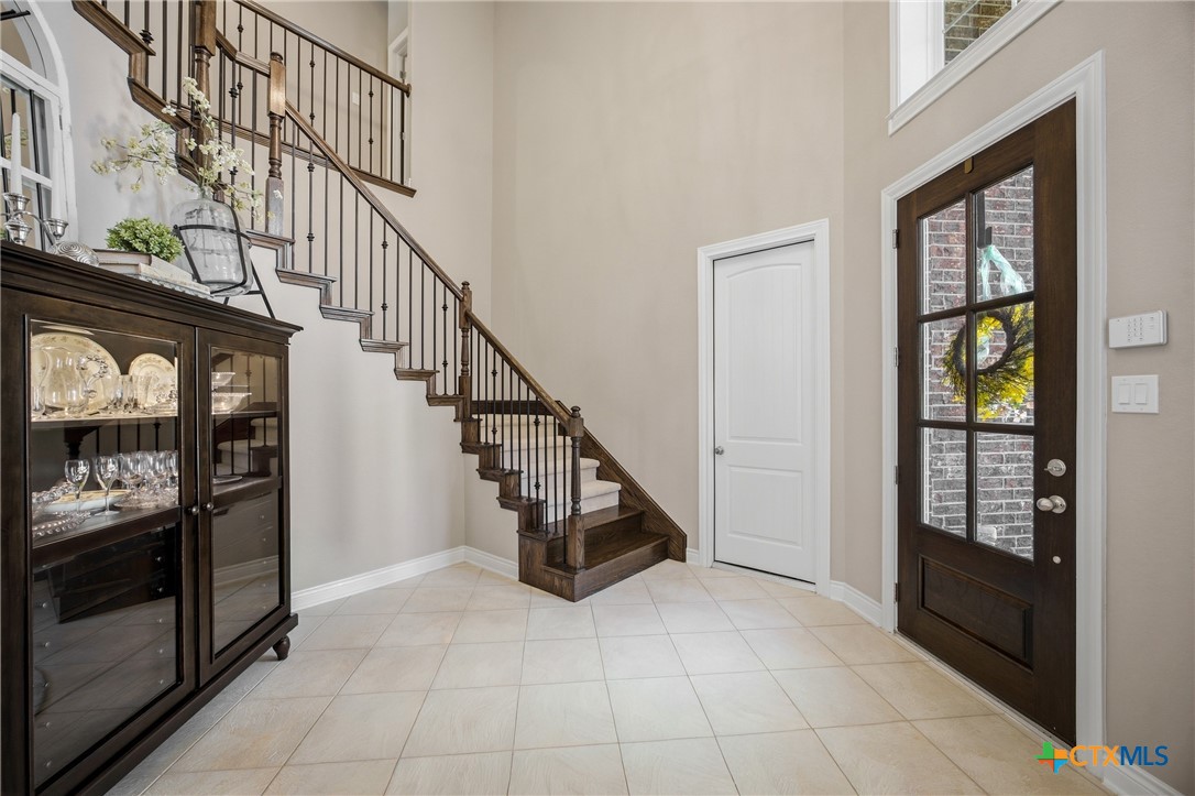 2427 Anderson Point Lane Spring, TX 77388 - Photo 10 of 47 a view of an entryway with wooden floor leading to a furnished livingroom and windows