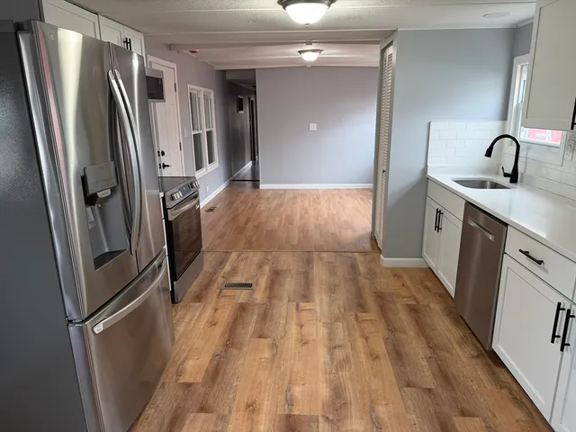 a view of a kitchen from the hallway
