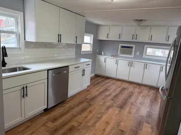 a kitchen with cabinets appliances and a sink