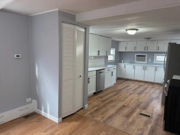 a kitchen with a sink window and cabinets