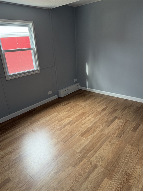 181 Boston Post Road East, Unit 26 Marlborough, MA 01752 - Photo 6 of 14 a view of room and hall with wooden floor