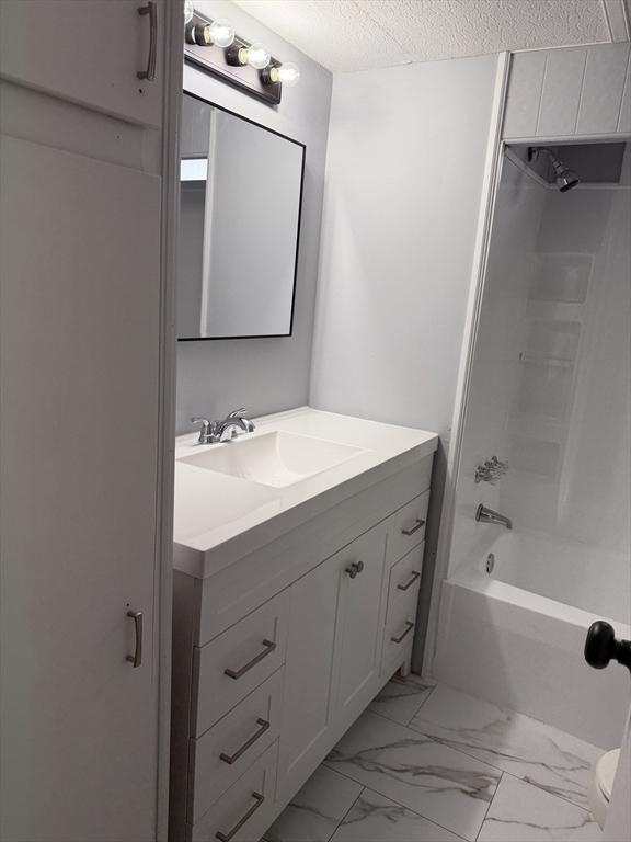 181 Boston Post Road East, Unit 26 Marlborough, MA 01752 - Photo 9 of 14 a bathroom with a sink a mirror and a bathtub