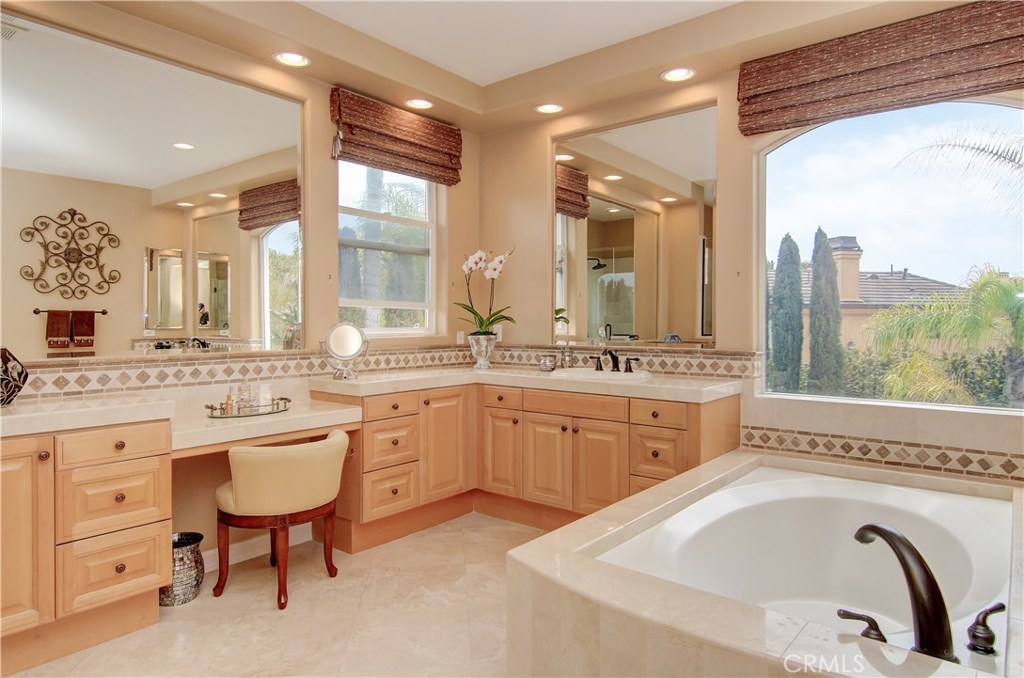 21 Asilomar Road Laguna Niguel, CA 92677 - Photo 11 of 35 a spacious bathroom with a granite countertop sink and a large mirror
