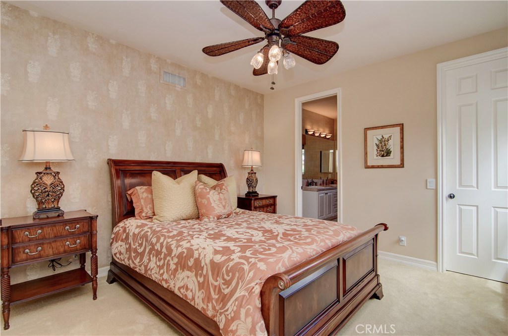 21 Asilomar Road Laguna Niguel, CA 92677 - Photo 16 of 35 a bedroom with a bed and a chandelier