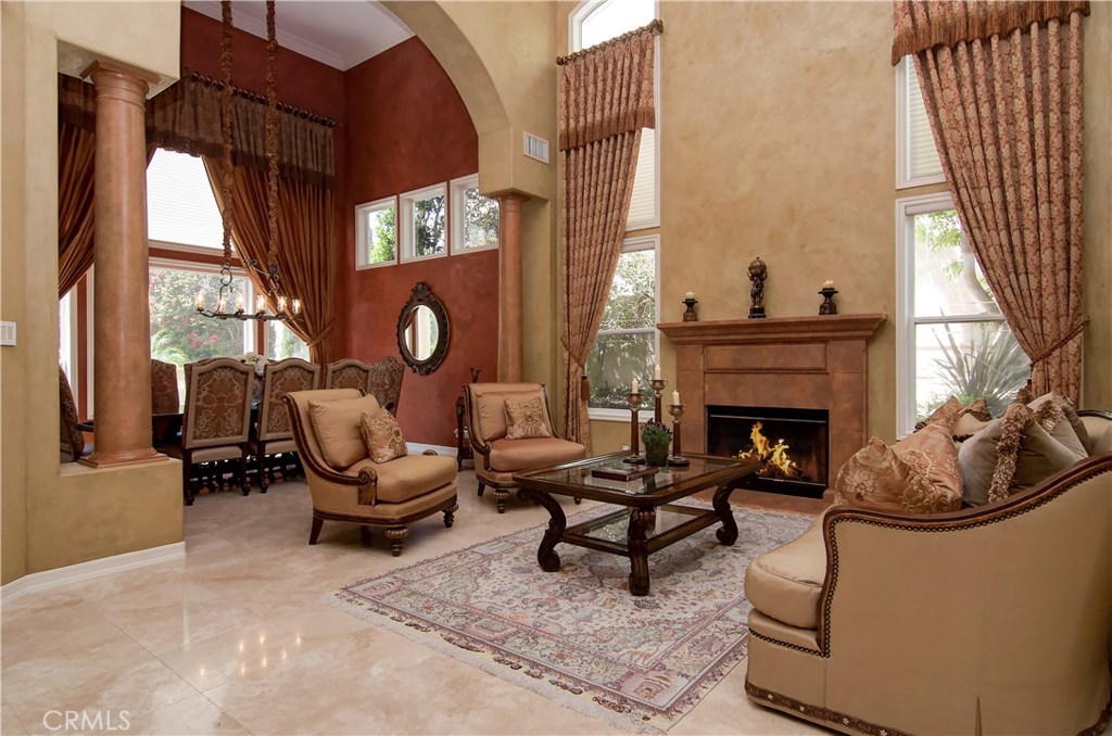 21 Asilomar Road Laguna Niguel, CA 92677 - Photo 19 of 35 a living room with furniture a fireplace and a large window