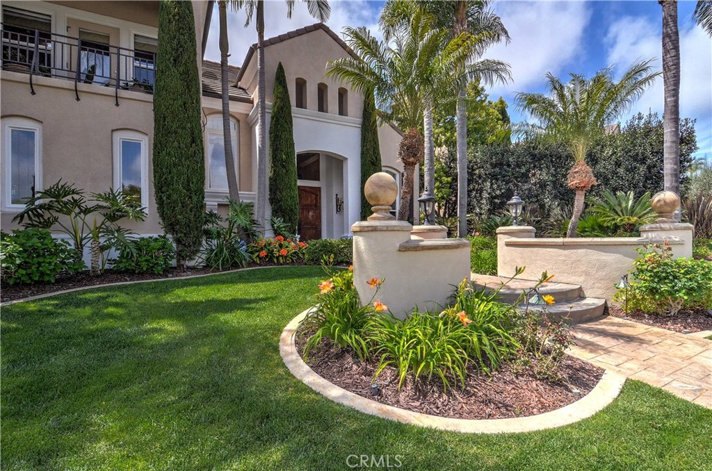 21 Asilomar Road Laguna Niguel, CA 92677 - Photo 34 of 35 a view of a house with a small yard plants and a fountain