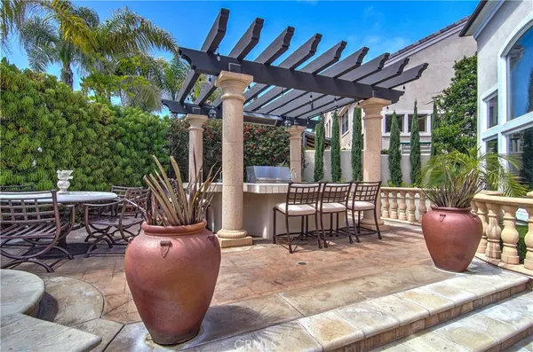 a view of a patio with couches chairs and potted plants