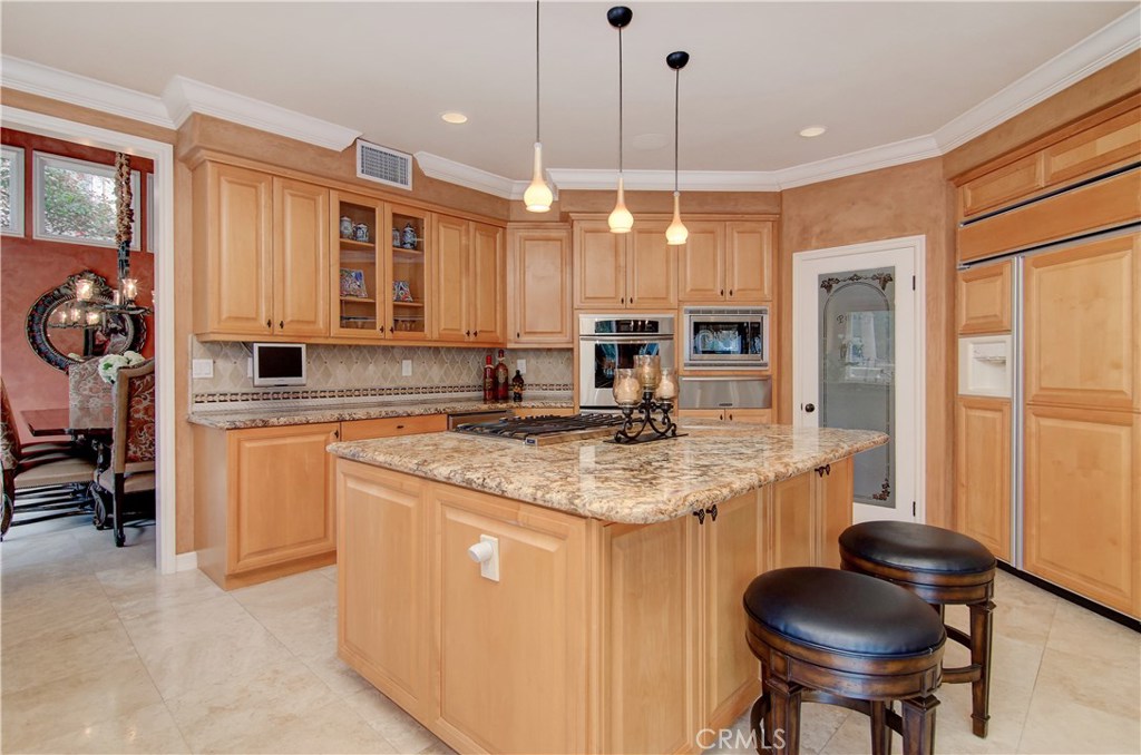 21 Asilomar Road Laguna Niguel, CA 92677 - Photo 6 of 35 a kitchen with stainless steel appliances granite countertop a sink a stove and a wooden floors